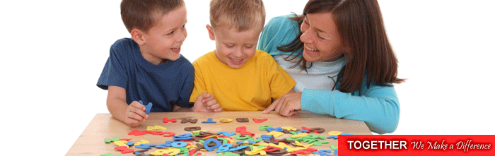 A mother and her two sons playing with letters